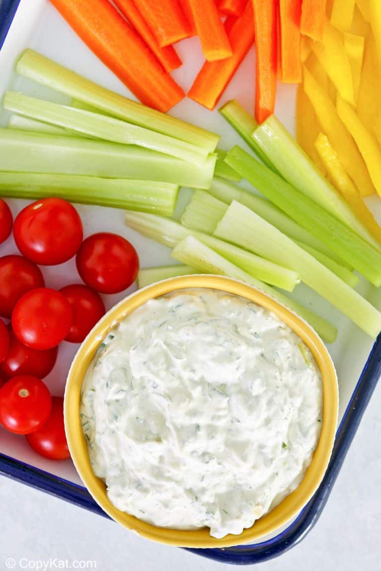 overhead view of green goddess dip and vegetables on a tray.