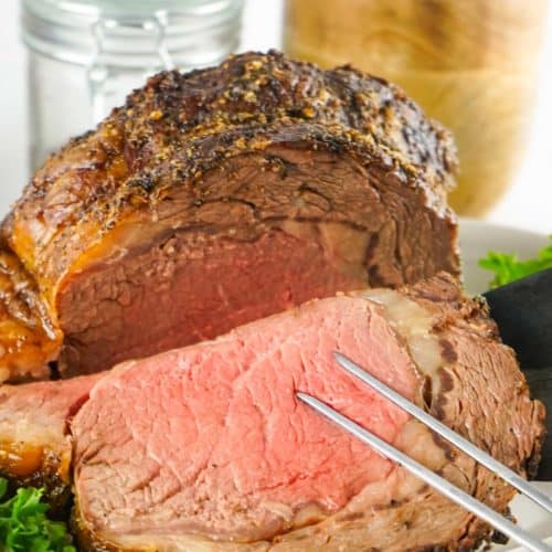 slicing a prime rib ribeye roast.