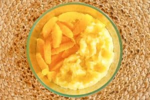 orange segments and crushed pineapple in a bowl.