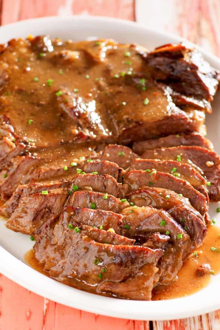to die for beef roast and gravy on a platter.