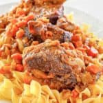 braised short ribs with noodles on a platter.