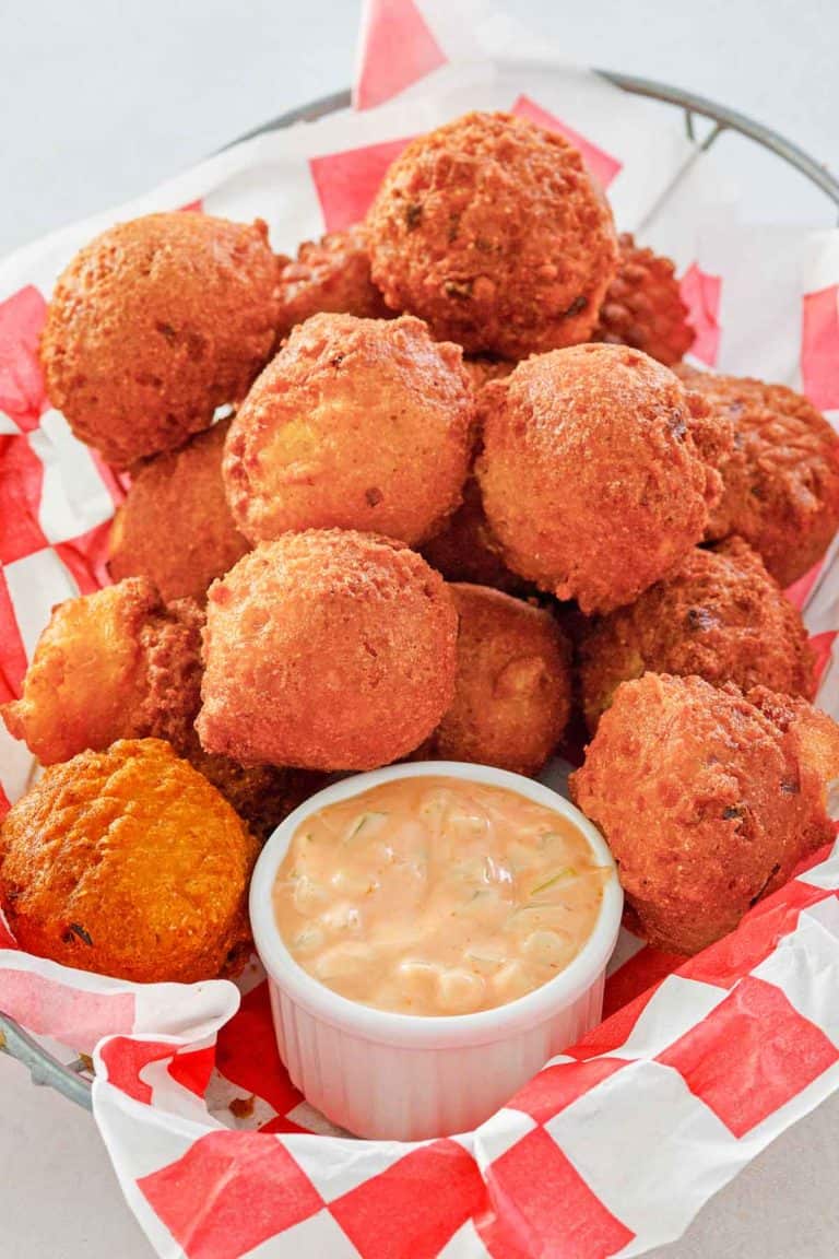 homemade hush puppies and remoulade sauce in a basket.