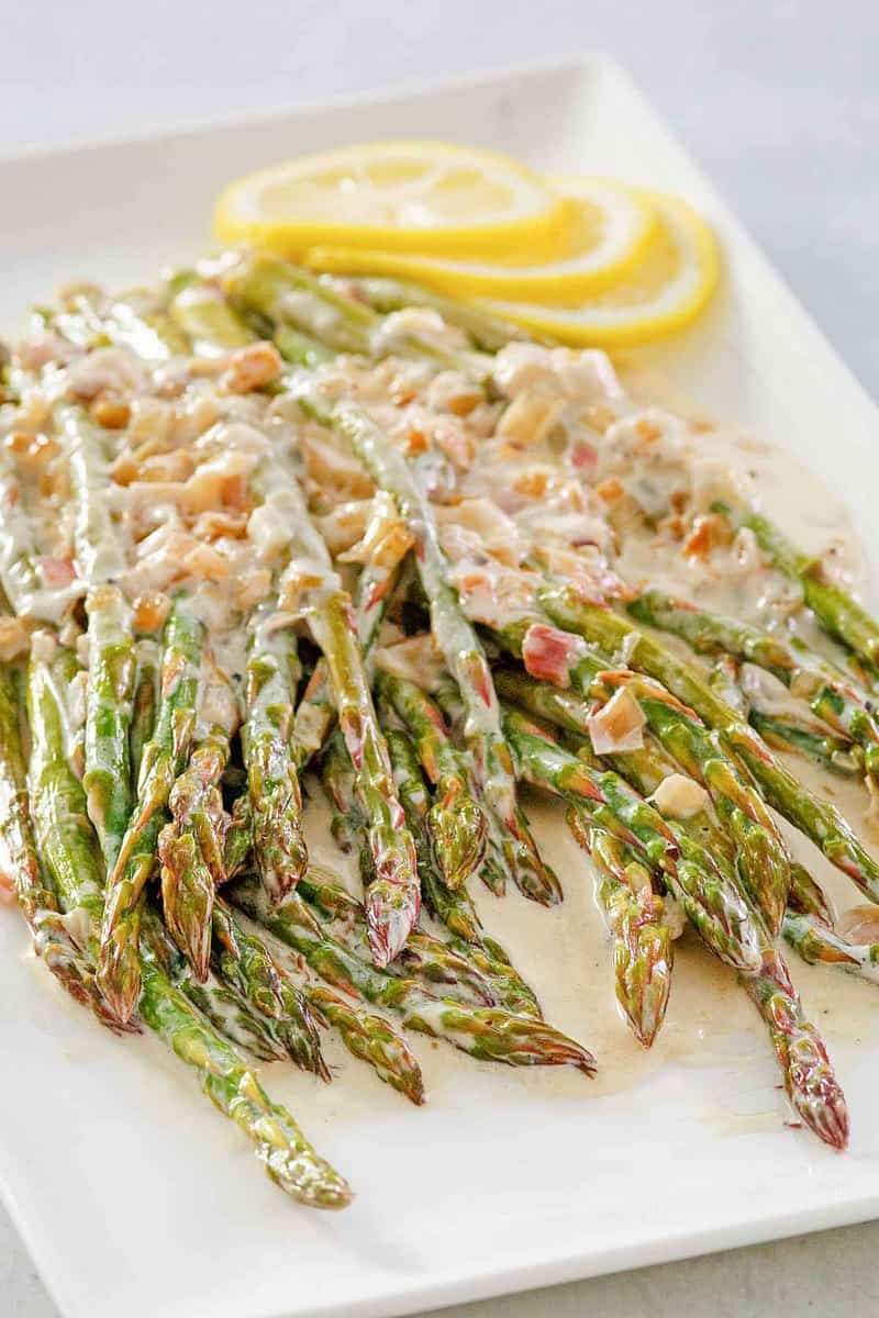 sauteed asparagus with lemon cream sauce on a platter.