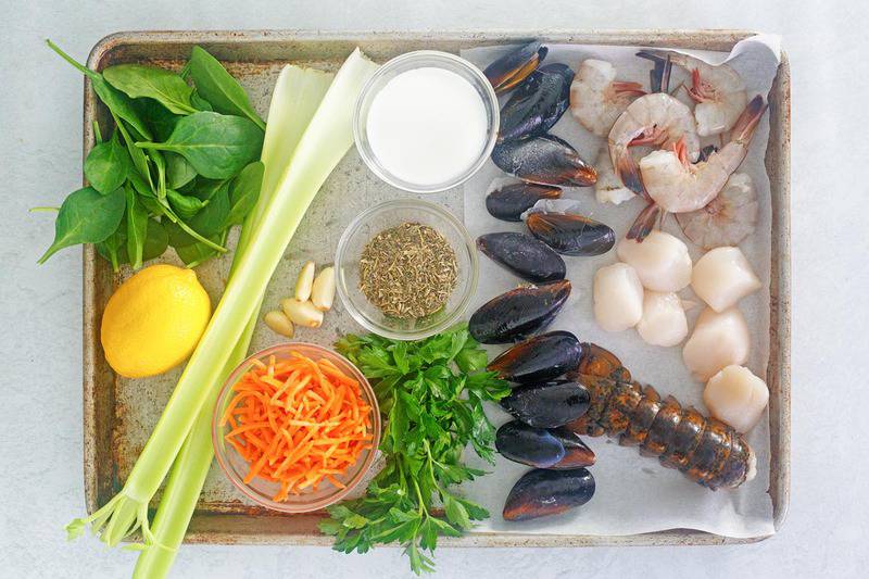 seafood bisque ingredients on a baking sheet.