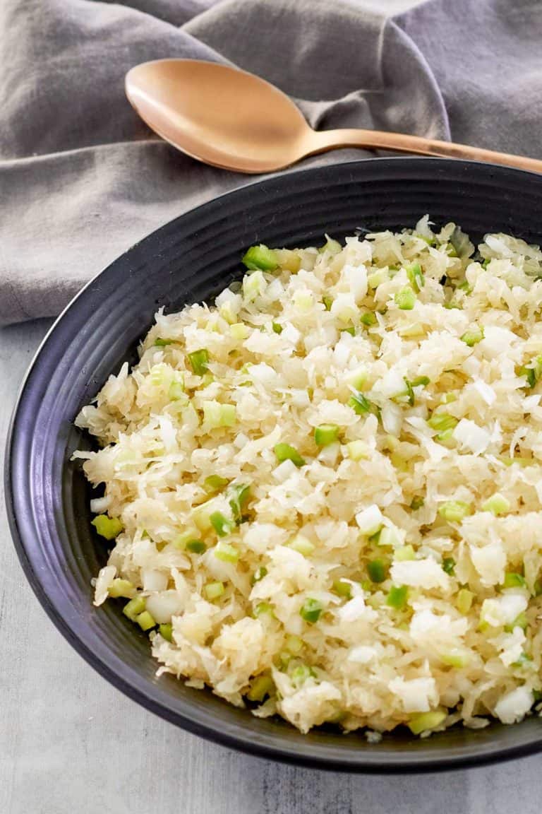 sauerkraut salad in a bowl and a spoon next to it.
