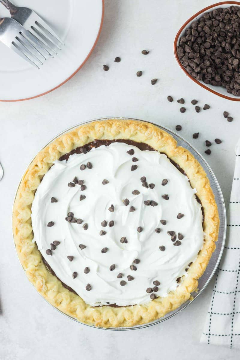 overhead view of a chocolate pie with whipped cream topping.