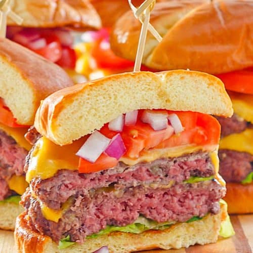homemade double garlic burger with cheese, lettuce, tomato, and onion.