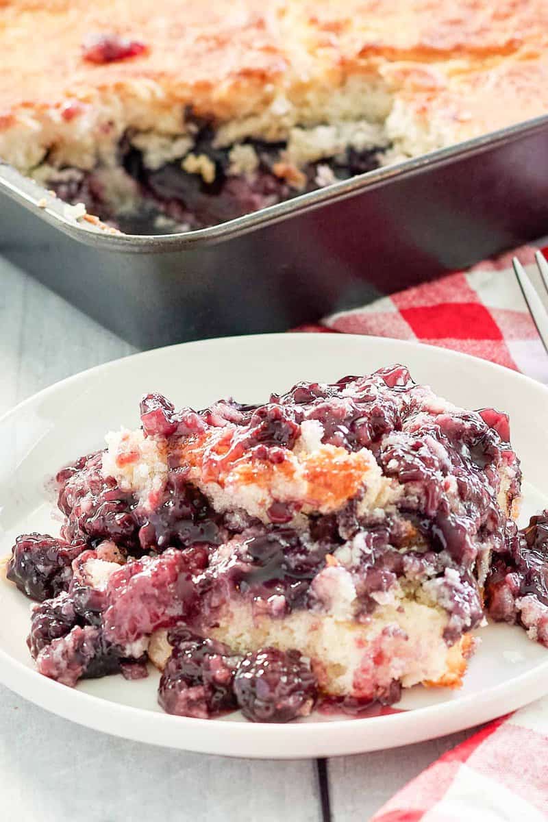blackberry cobbler on a plate and in a baking pan.