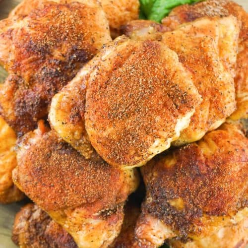 overhead view of smoked chicken thighs on a platter.