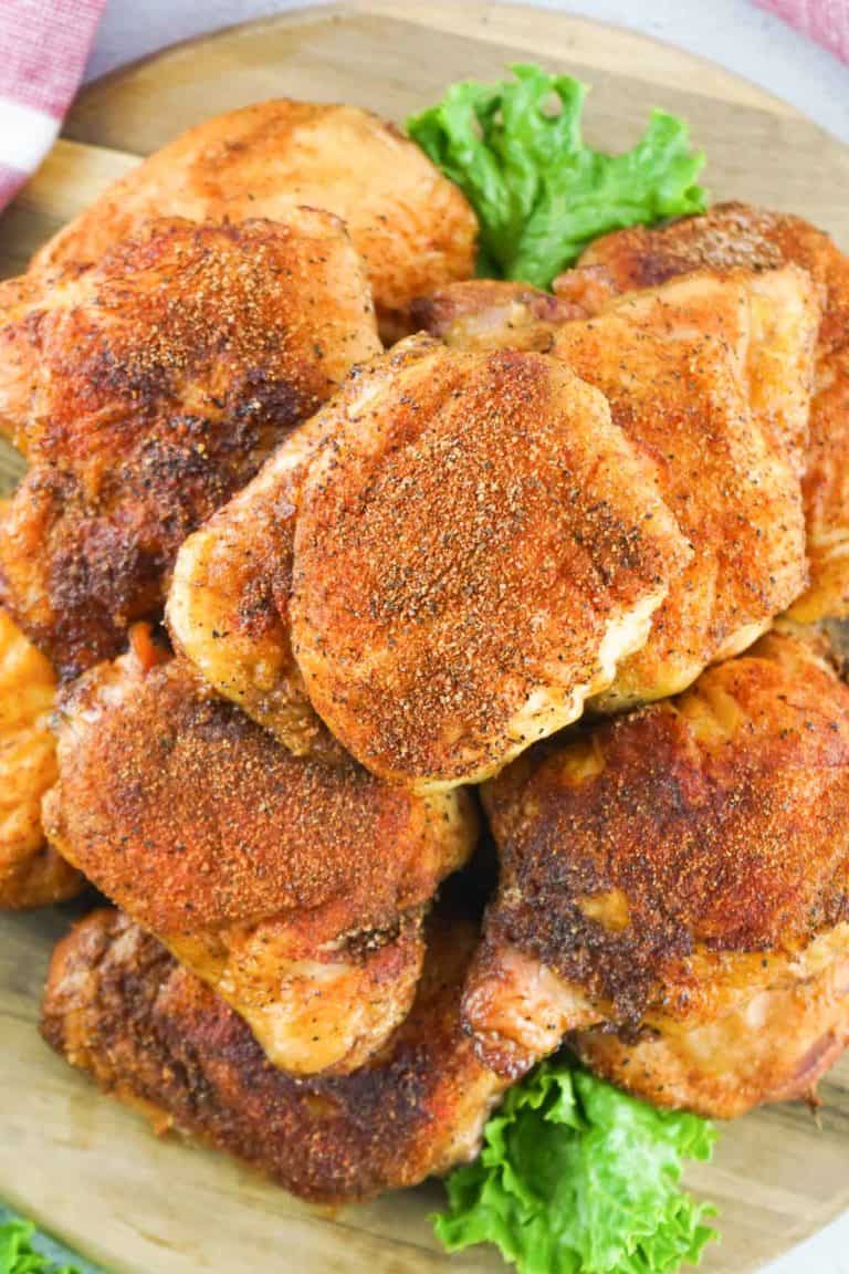 overhead view of smoked chicken thighs on a platter.