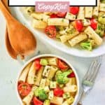 overhead view of pasta salad with broccoli and tomatoes.