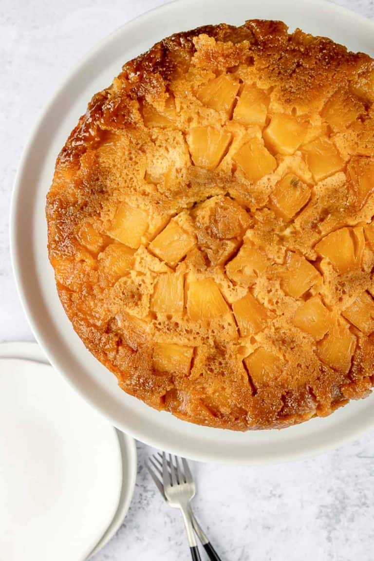 overhead view of pineapple upside down cake on a cake plate.