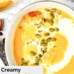 bowl of pumpkin bisque topped with pumpkin seeds.