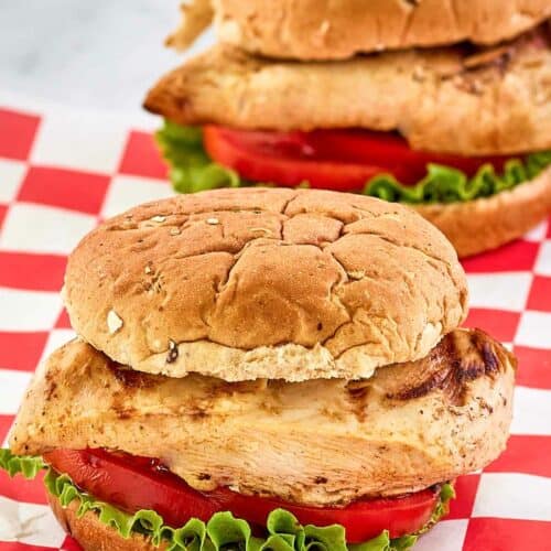 two copycat Chick Fil A grilled chicken sandwiches.