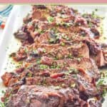sliced stove top pot roast on a white platter.