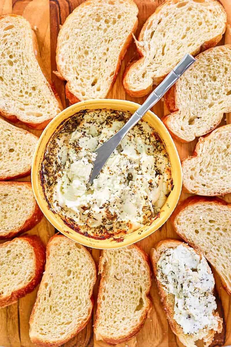 Italian seasoned baked goat cheese and bread slices around it.
