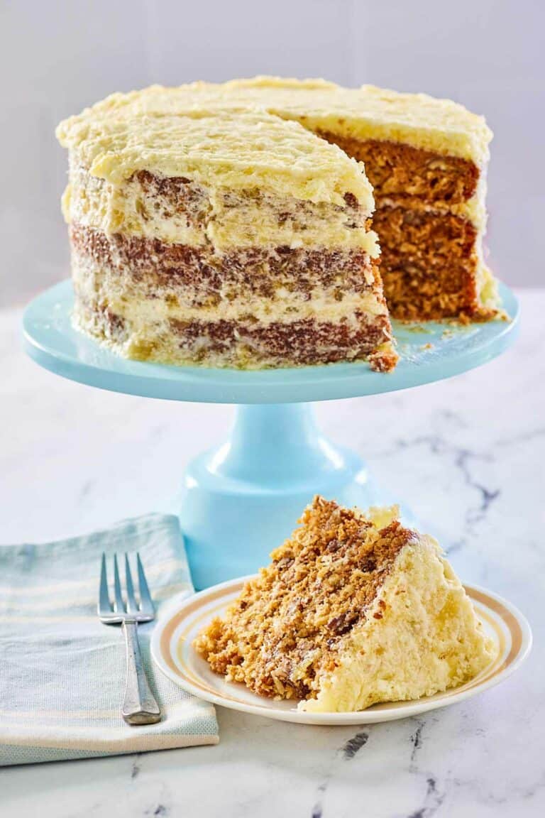 Hawaiian Cake on a blue cake stand and a slice on a plate.