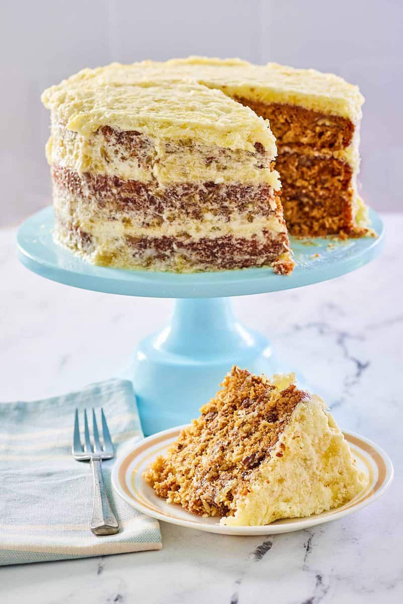 Hawaiian Cake on a blue cake stand and a slice on a plate.