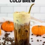 homemade Starbucks pumpkin cream cold brew, coffee beans, and small pumpkins.