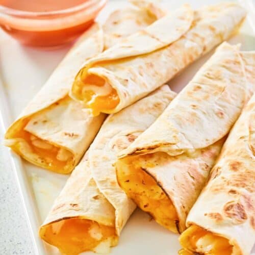 five copycat Taco Bell cheesy roll ups on a platter.
