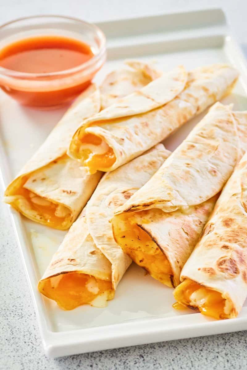 five copycat Taco Bell cheesy roll ups on a platter.