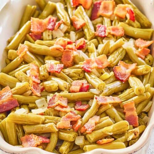 copycat Texas Roadhouse green beans with bacon and onions in a serving dish.