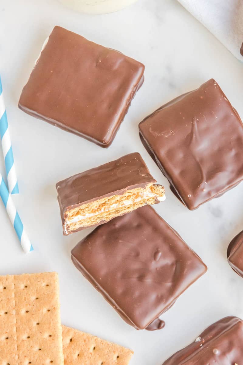 dipped S'mores cookies with one cut in half to show the filling.