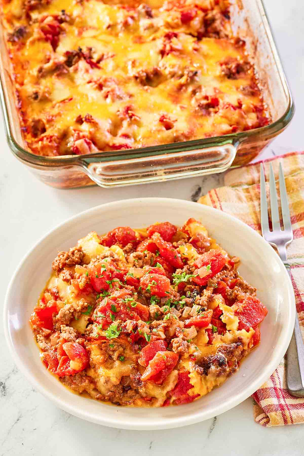 hamburger hash with cheese in a baking dish and bowl.