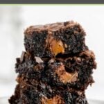 three milky way brownies stacked on a white plate.