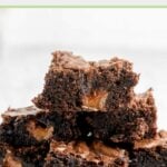 milky way brownies stacked on a white plate.