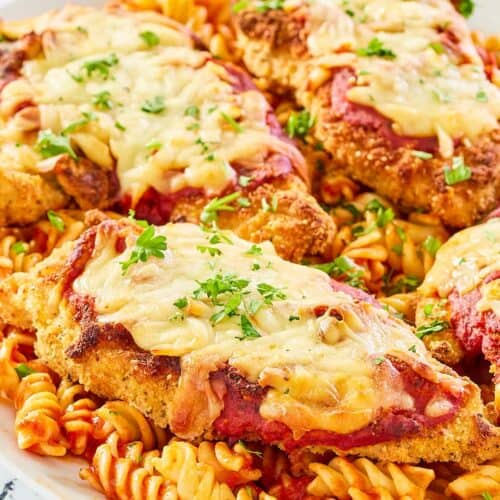 copycat Olive Garden chicken parmigiana and pasta on a platter.