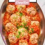 overhead view of homemade Olive Garden meatballs and marinara in a copper skillet.