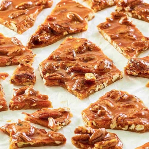 pecan brittle pieces scattered on parchment.
