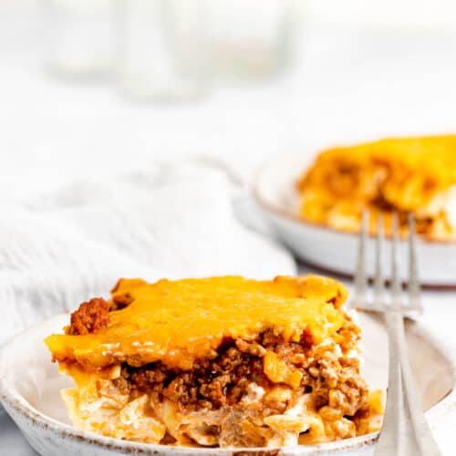sour cream noodle bake serving and a fork on a plate.