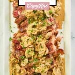 overhead view of steak marsala on a rectangular white platter.