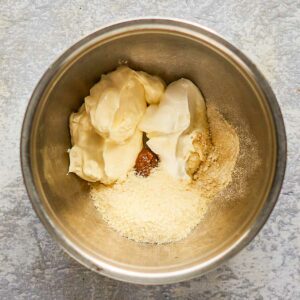 creamy caesar dressing ingredients in a mixing bowl.