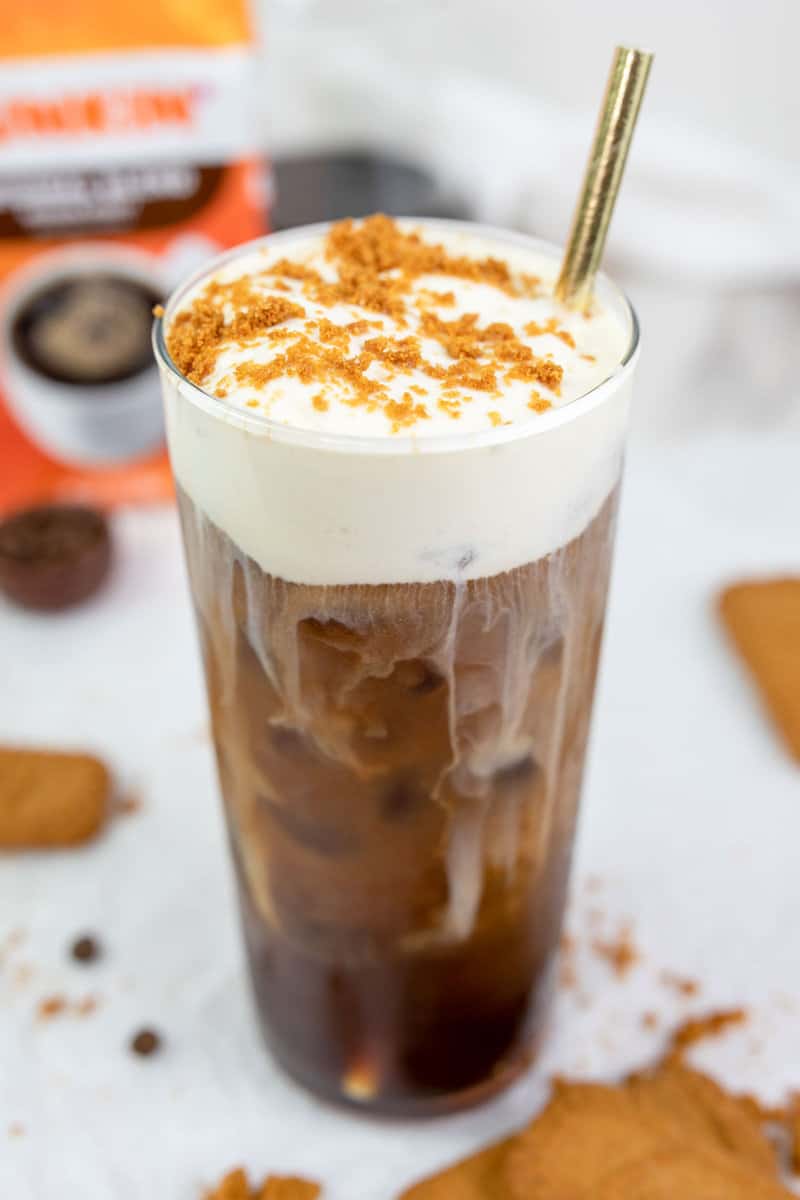 copycat Dunkin cookie butter cold brew with cold foam and a straw.