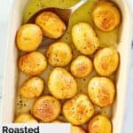 overhead view of roasted baby potatoes and a spoon in a baking dish.