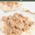 homemade beef stroganoff over rice on a white plate.