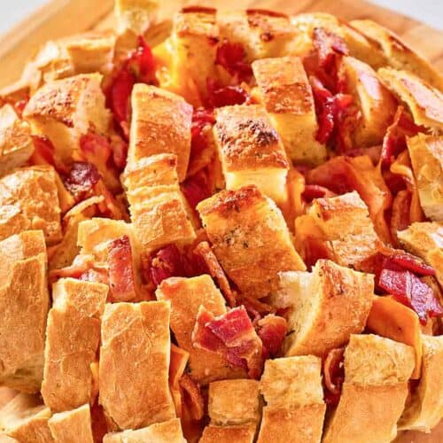 cheesy pull apart bread on a wood board.