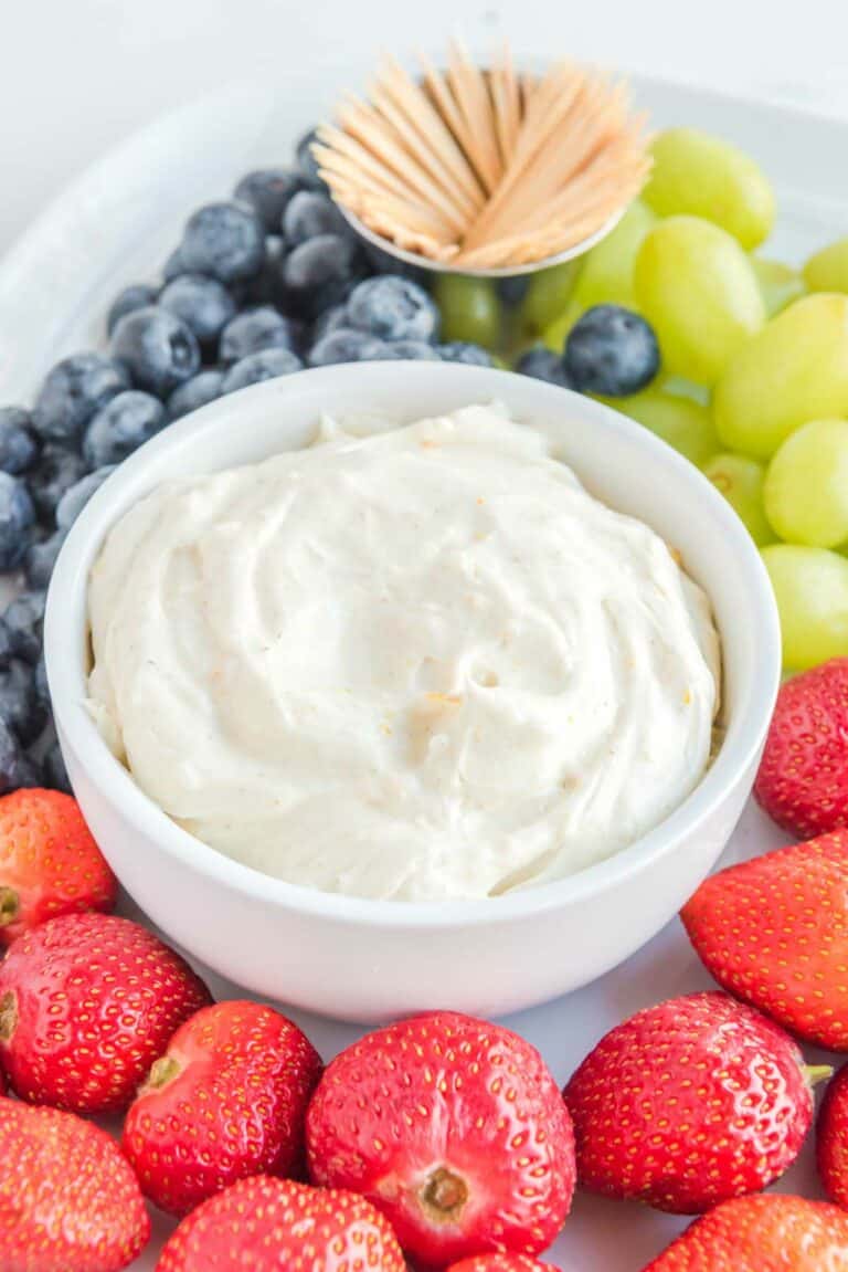 Cream cheese fruit dip, strawberries, grapes, blueberries, and toothpicks.
