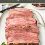 Slices of cooked New York strip roast on a platter.