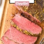 Overhead view of a cooked New York strip roast on a cutting board.