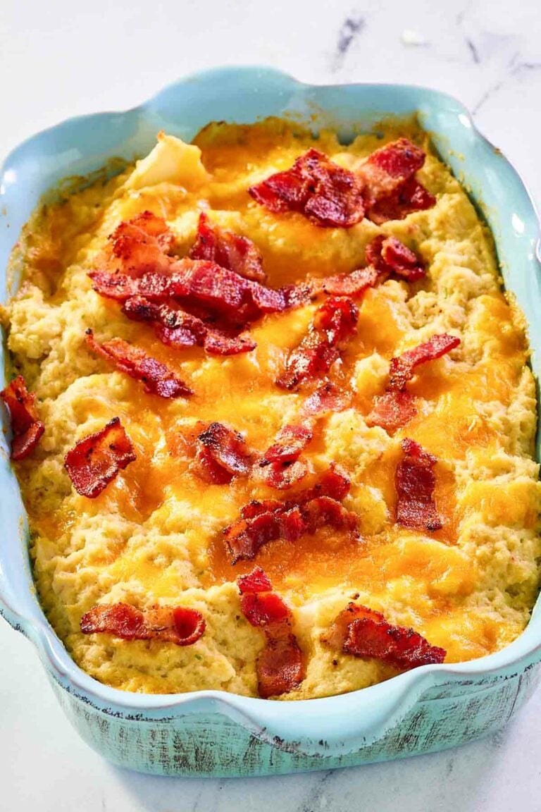Twice baked cauliflower in a blue casserole dish.