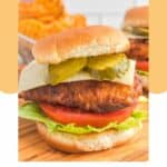Homemade Chick Fil A spicy deluxe chicken sandwich on a wood board.