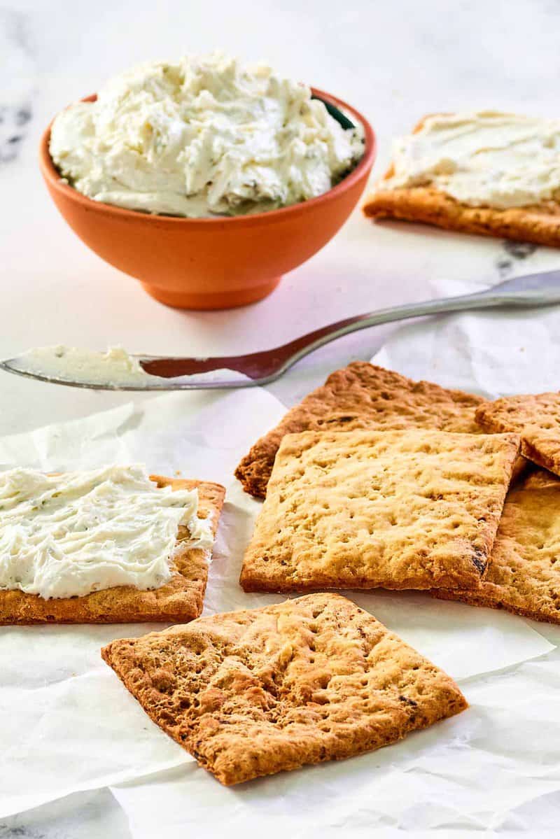 Homemade crackers and a bowl of a cheese spread.