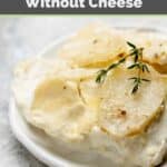 Creamy scalloped potatoes without cheese on a white plate.