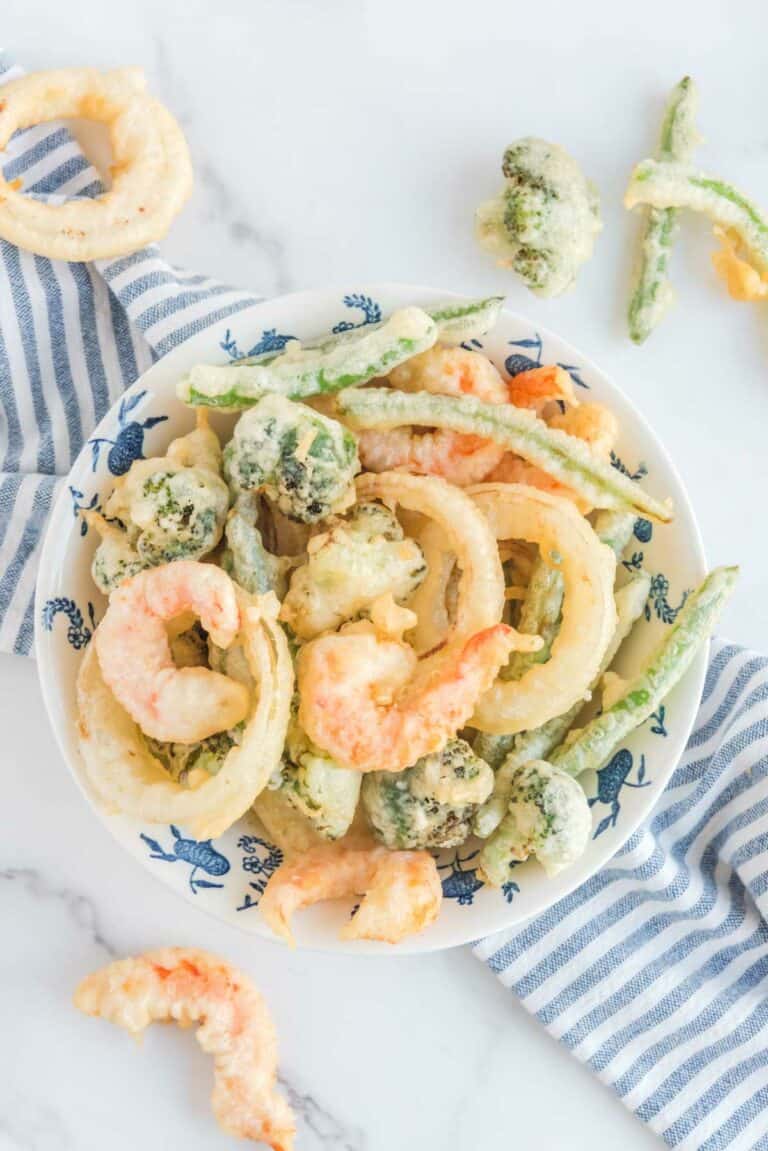 Overhead view of homemade tempura batter fried vegetables and shrimp.