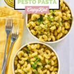Overhead view of homemade Alonti pecan pesto pasta in two bowls and forks on napkins.