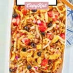 Overhead view of frito taco salad with catalina dressing on a large white platter.